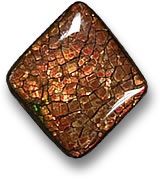 Красновато-коричневый кабошон из аммолита