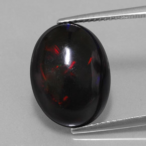 Натуральный многоцветный чёрный опал 5,63 карата огранка овал, непрозрачный