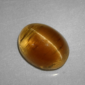 Натуральный жёлтый cat's eye apatite 3,32 карата огранка овал, полупрозрачный