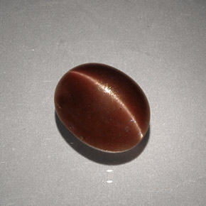 Натуральный коричневый cat's eye scapolite 2,56 карата огранка овал, непрозрачный