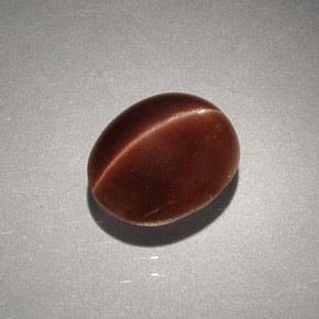 Натуральный коричневый cat's eye scapolite 2,56 карата огранка овал, непрозрачный