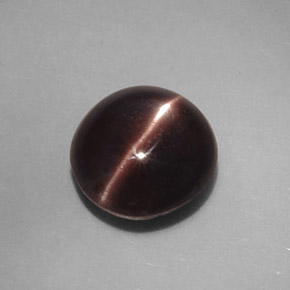Натуральный коричневый cat's eye scapolite 3,46 карата огранка овал, непрозрачный