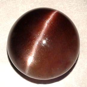 Натуральный коричневый cat's eye scapolite 11,06 карата огранка круг, полупрозрачный