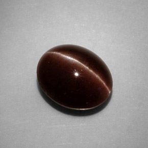 Натуральный коричневый cat's eye scapolite 3,52 карата огранка овал, непрозрачный
