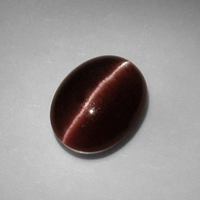 Натуральный коричневый cat's eye scapolite 3,41 карата огранка овал, непрозрачный