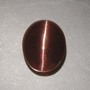Натуральный коричневый cat's eye scapolite 2,32 карата огранка овал, непрозрачный