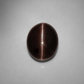 Натуральный коричневый cat's eye scapolite 6,90 карата огранка овал, полупрозрачный