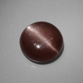 Натуральный коричневый cat's eye scapolite 2,40 карата огранка круг, непрозрачный