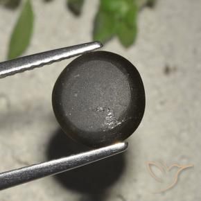 Натуральный чёрный cat's eye scapolite 2,72 карата огранка круг, полупрозрачный
