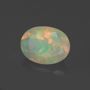 Натуральный многоцветный опал 0,92 карата огранка овал, прозрачный
