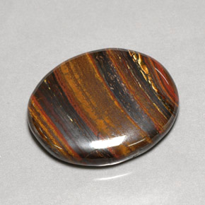 Натуральный многоцветный tiger's eye matrix 53,09 карата огранка овал, непрозрачный