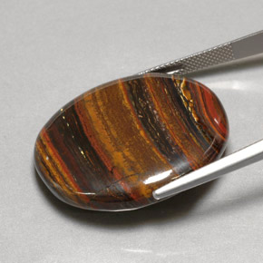 Натуральный многоцветный tiger's eye matrix 53,09 карата огранка овал, непрозрачный