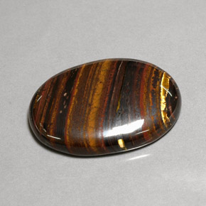 Натуральный многоцветный tiger's eye matrix 43,53 карата огранка овал, непрозрачный