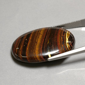 Натуральный многоцветный tiger's eye matrix 43,53 карата огранка овал, непрозрачный