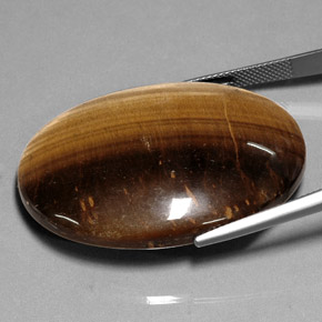 Натуральный коричневый tiger's eye 75,05 карата огранка овал, непрозрачный