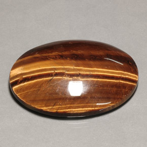 Натуральный коричневый tiger's eye 74,22 карата огранка овал, непрозрачный