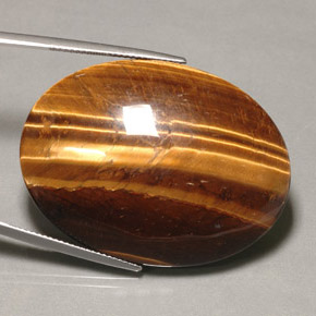 Натуральный коричневый tiger's eye 74,22 карата огранка овал, непрозрачный