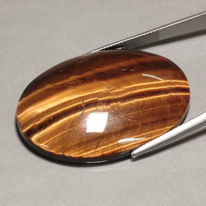 Натуральный коричневый tiger's eye 74,22 карата огранка овал, непрозрачный
