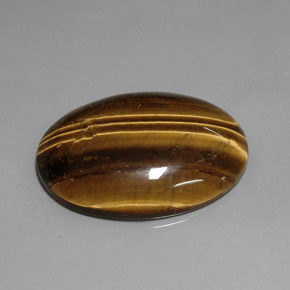 Натуральный коричневый tiger's eye 76,92 карата огранка овал, непрозрачный