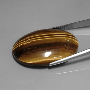 Натуральный коричневый tiger's eye 76,92 карата огранка овал, непрозрачный