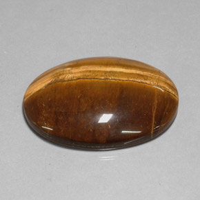 Натуральный коричневый tiger's eye 78,13 карата огранка овал, непрозрачный