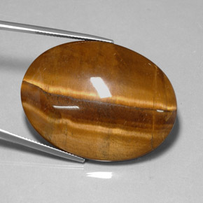 Натуральный коричневый tiger's eye 78,13 карата огранка овал, непрозрачный