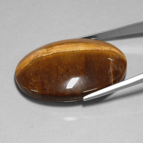 Натуральный коричневый tiger's eye 78,13 карата огранка овал, непрозрачный