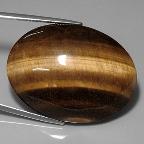 Натуральный коричневый tiger's eye 76,52 карата огранка овал, непрозрачный