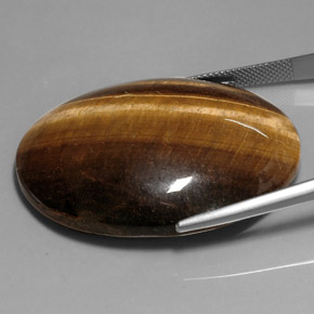 Натуральный коричневый tiger's eye 76,52 карата огранка овал, непрозрачный
