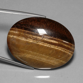 Натуральный коричневый tiger's eye 80,28 карата огранка овал, непрозрачный
