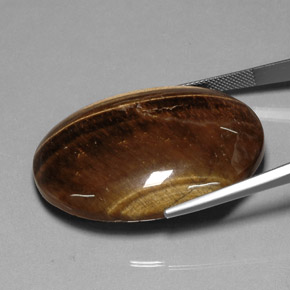 Натуральный коричневый tiger's eye 80,28 карата огранка овал, непрозрачный