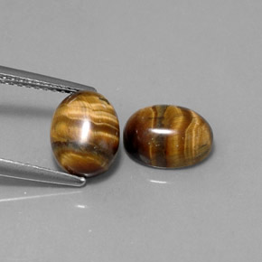 Натуральный коричневый tiger's eye  карата огранка овал, непрозрачный