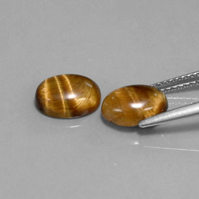 Натуральный коричневый tiger's eye  карата огранка овал, непрозрачный