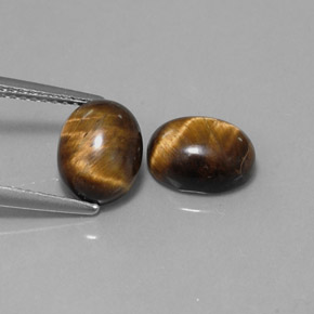 Натуральный коричневый tiger's eye  карата огранка овал, непрозрачный
