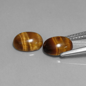 Натуральный коричневый tiger's eye  карата огранка овал, непрозрачный