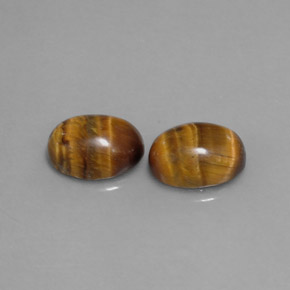 Натуральный коричневый tiger's eye  карата огранка овал, непрозрачный
