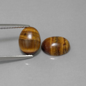 Натуральный коричневый tiger's eye  карата огранка овал, непрозрачный