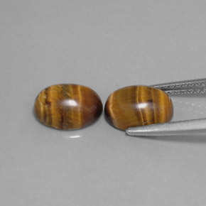 Натуральный коричневый tiger's eye  карата огранка овал, непрозрачный