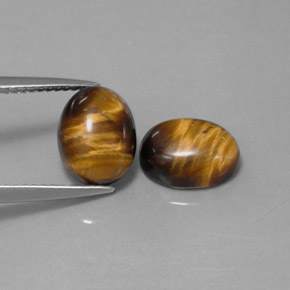 Натуральный коричневый tiger's eye  карата огранка овал, непрозрачный