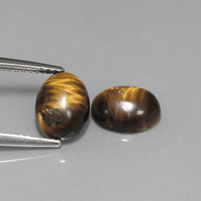 Натуральный коричневый tiger's eye  карата огранка овал, непрозрачный