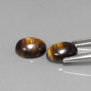 Натуральный коричневый tiger's eye  карата огранка овал, непрозрачный