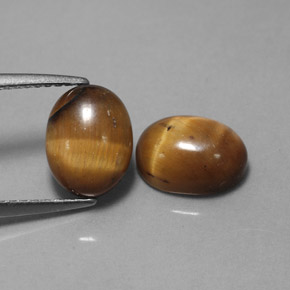 Натуральный коричневый tiger's eye  карата огранка овал, непрозрачный