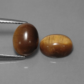 Натуральный коричневый tiger's eye  карата огранка овал, непрозрачный