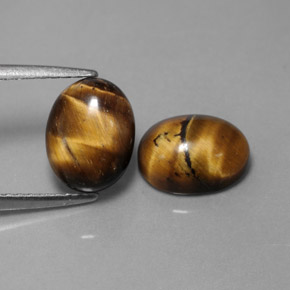 Натуральный коричневый tiger's eye  карата огранка овал, непрозрачный