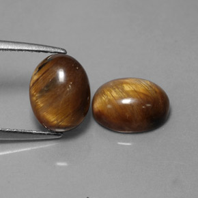 Натуральный коричневый tiger's eye  карата огранка овал, непрозрачный