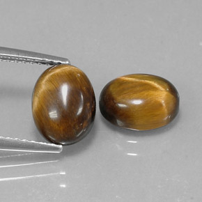 Натуральный коричневый tiger's eye  карата огранка овал, непрозрачный
