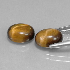 Натуральный коричневый tiger's eye  карата огранка овал, непрозрачный