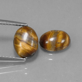 Натуральный коричневый tiger's eye  карата огранка овал, непрозрачный