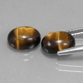 Натуральный коричневый tiger's eye  карата огранка овал, непрозрачный
