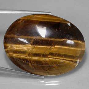 Натуральный коричневый tiger's eye 73,05 карата огранка овал, непрозрачный